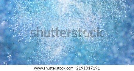 Background of many small white bubbles or air balls in clear blue water
