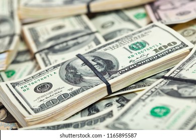 Background of many US dollars banknotes - Shutterstock ID 1165895587