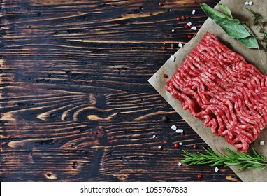 background with meat. ground beef on old dark wood background.