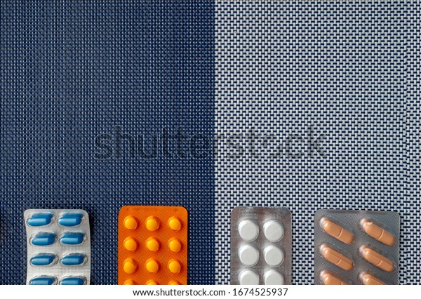 Background with medical\
preparations and with place for text. The background is divided in\
color into two halves. The drugs in the blisters are located at the\
bottom.