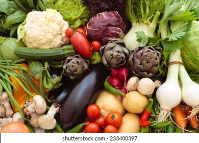Background of mixed fresh organic vegetables and herbs.