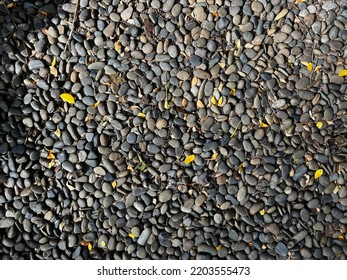 Background Of Mixed Small Rough Stone In The Garden.