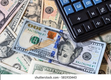 Background with money american dollar bills and black calculator. Cash money.