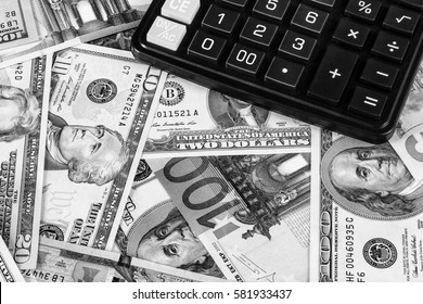 Background with money american dollar and euro bills and black calculator. Cash money. Black and white image.