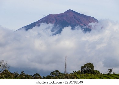 background of mountains covered with clouds in the evening. the mountain looks blurry and dark.