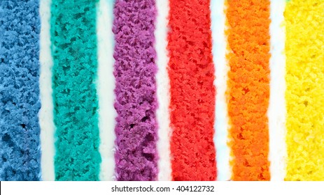 Background of multicolor six layer cake. Low shallow of depth. Rainbow cake texture. Color background