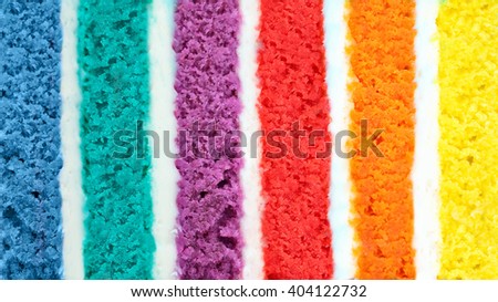 Background of multicolor six layer cake. Low shallow of depth. Rainbow cake texture. Color background
