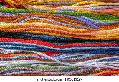 background of multi-colored threads of floss braided threads for embroidery