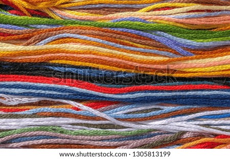 background of multi-colored threads of floss braided threads for embroidery