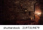 Background of mystical dark interior of medieval room with large wooden door and skull on table against an ancient stone wall. Amazing backgrounds for Halloween holiday. Copy space, text place