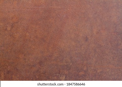 Background Of Natural Brown Old Saddle Leather With Spots