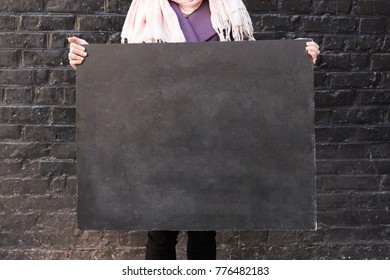 background  negative space  arts   crafts concept  close up small   clean school blackboard in the arms woman that is holding it the edges
