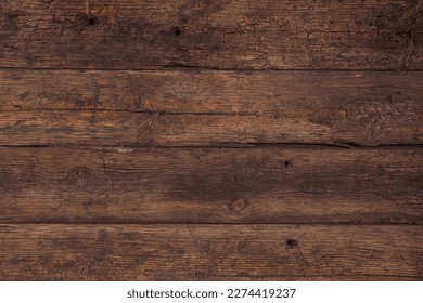 Background of old brown boards with visible grain and damage.