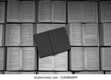 Background  Of Old Text Books Laying On A Table. For Overlaying With Text Or Place A Digital Product Mockup In The Foreground Of Cover. Mock Of Empty Grey Hardcover Book. Blurred Text In Opened Books