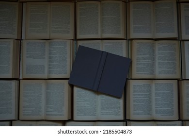 Background  Of Old Text Books Laying On A Table. For Overlaying With Text Or Place A Digital Product Mockup In The Foreground Of Cover. Mock Of Empty Grey Hardcover Book. Blurred Text In Opened Books