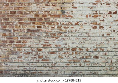 Background of old vintage dirty brick wall with peeling plaster, texture - Shutterstock ID 199884215