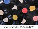 background of old vinyl records of different sizes and colors. possible concept: background, showcase, advertising