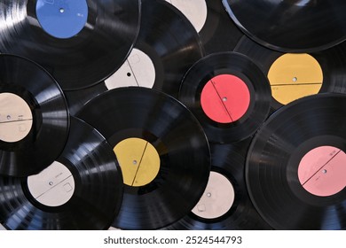 background of old vinyl records of different sizes and colors. possible concept: background, showcase, advertising