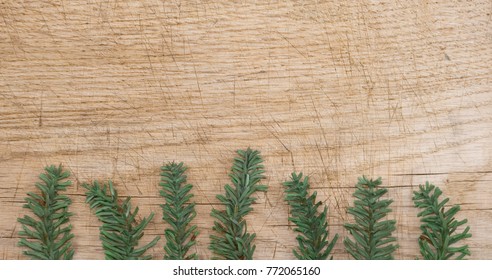 Background: old wooden plank in brown and beige, with a border, frame, made with pine branches, fake, made of plastic, green, christmas, winter, Italy - Powered by Shutterstock