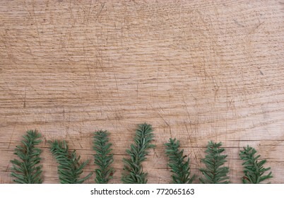 Background: old wooden plank in brown and beige, with a border, frame, made with pine branches, fake, made of plastic, green, christmas, winter, Italy - Powered by Shutterstock