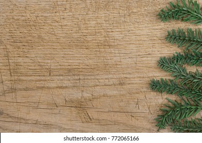 Background: old wooden plank in brown and beige, with a border, frame, made with pine branches, fake, made of plastic, green, christmas, winter, Italy - Powered by Shutterstock