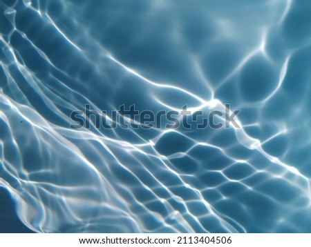Abstract​ of surface​ blue​ water​ for​ background. Reflection​ on surface​ blue​ water​ for​ background. Water​ splashed​ for​ background. Water​ texture​ for​ graphic​ design. Blue​ water texture.
