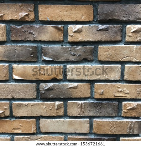 Background of orange with dark brick wall texture