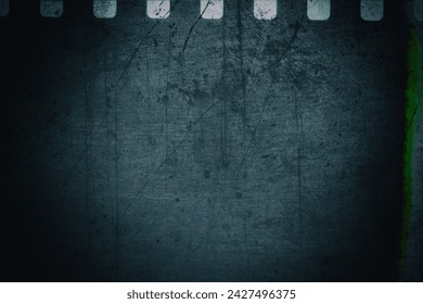 Background with original 35mm film reel with empty dusty frames or cells and nice texture on the border, fluff on the film stock, real film grain - Powered by Shutterstock