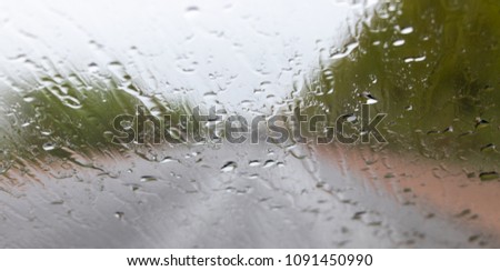 the background is out of focus. view from the window of a car in the rain