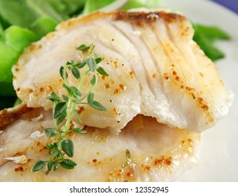 Background of pan fried Pearl Perch with and salad.