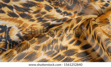 background pattern African fabric with silk print with tiger print. This amazing fabric will help you to plunge into the world of unbridled savannah. 
