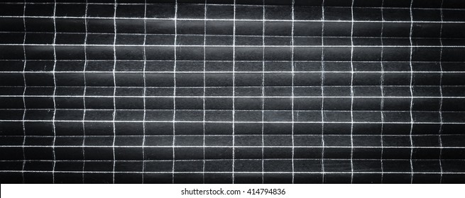 Background pattern of folded black paper in 256 parts with selective focus and under exposure
