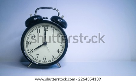 Background photo of an alarm clock showing 8:00 o'clock, isolated on white background