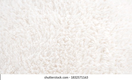 Background picture of a soft fur white carpet. wool sheep fleece closeup texture background. Fake color beige fur fabric. top view. - Shutterstock ID 1832571163