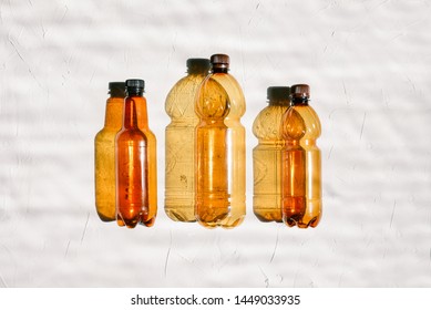 Background of plastic bottles. Three empty bottles in a row on a white background. Pollution and ecology concept. Recycling and disposal of garbage. Natural background