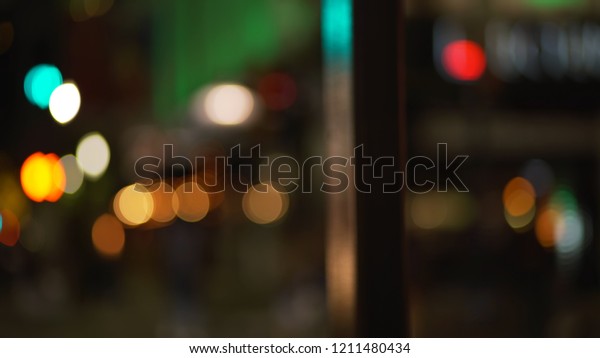 Background plate of out of focus city street\
sidewalk at night