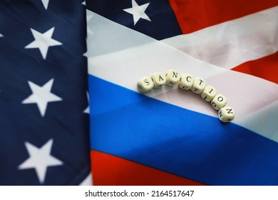 The Background Is Political. American And Russian Flag On Background. US Sanctions Against Russia. Exacerbation Of Dipomotic Relationships.