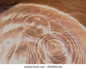 Abstract​ of​ surface​ blue​ water​ for​ background. Reflection​ of​ sunlight​ with​ surface​ blue​ water​ in​ the​ swimming​ pool.
