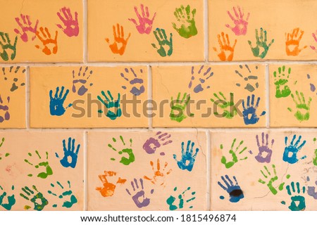 Background with a print of a bloody hands on a wall 