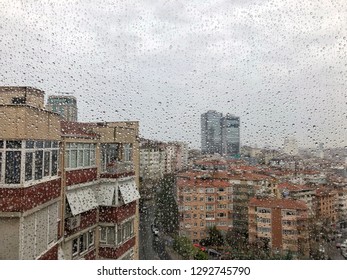 background with rain drops on window against city view