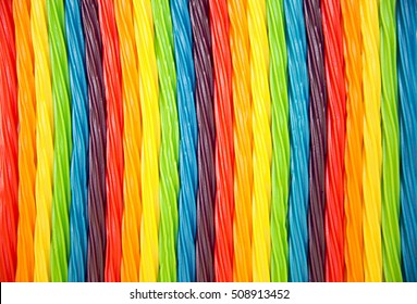 Background Of Rainbow Twisted Candy. Pride Flag Concept. Colorful Twisted Licorice Candy, Texture