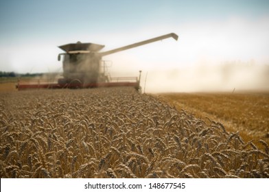 Background Reaper Harvesting A Wheat Field