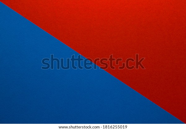 Background of red\
and blue paper divided diagonally. Sheets of blank blue and red\
paper with fine texture, close\
up.