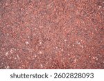 background with red granite tile texture. The texture of natural granite stone for the decoration of facades and sidewalks