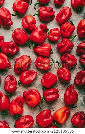 Background of Red Habanero Chili Peppers on a Light Concrete Surface
