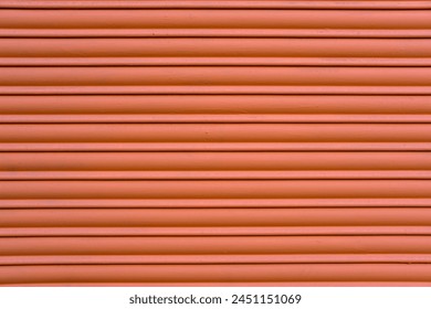 Background from a red painted roller shutter of a shop