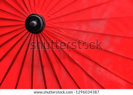 The background is a red umbrella.
