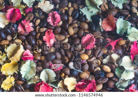 background of roasted coffee beans with colourful dried Potpourri