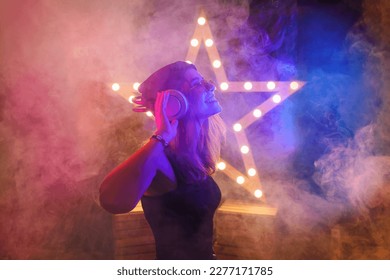Background room with dancing girl in headphones - spotlights and lights, abstract purple background with neon glow