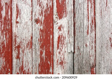 A Background Of Rustic, Aged Barnwood Boards, With Peeling Red Paint.